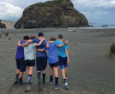 A group of people hugging on a beach